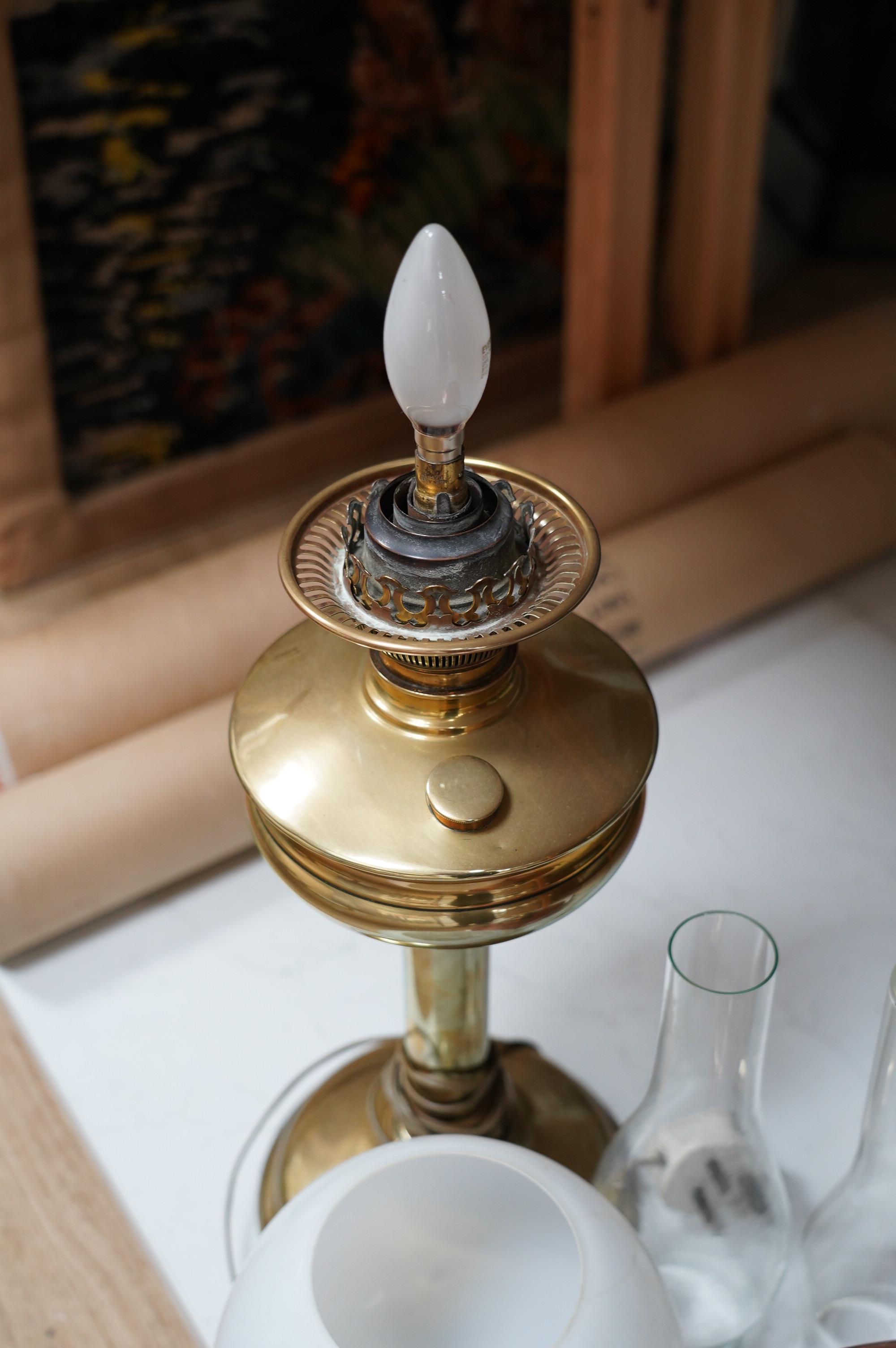 Two oil lamps to include a brass example with opaque glass shade. Condition - fair to good